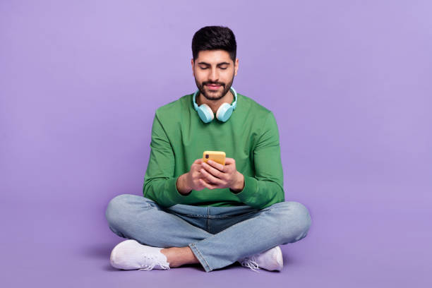 istock Full size photo of cheerful positive optimistic guy wear green pullover chatting typing comment post isolated on violet color background 2190247235