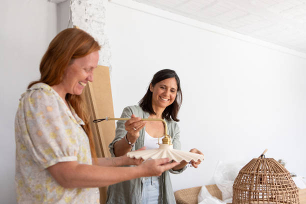 istock Female architects choosing the lamps of renovation project 2190249014