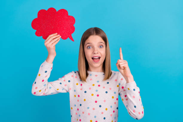 istock Photo of funny excited little lady dressed dotted pullover pointing finger red mind cloud empty space isolated blue color background 2190250059