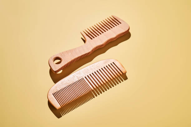 istock Two wooden combs on a yellow background. 2190251304