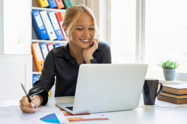 istock Beautiful business woman working with laptop 2190253452