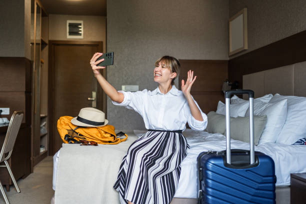 istock Woman having a video call in a hotel room 2190253586