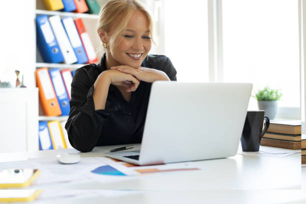 istock Beautiful business woman working with laptop 2190253596