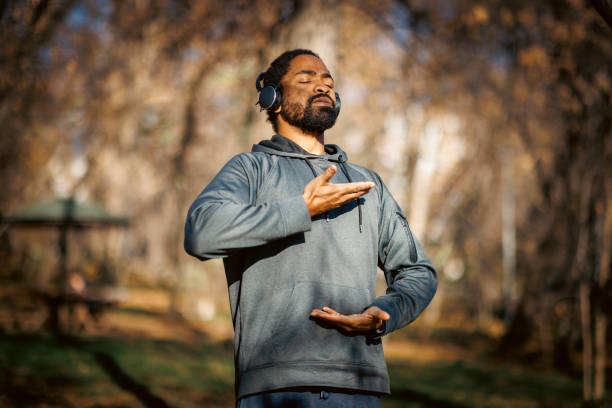istock Man meditating outdoors with headphones in autumn 2190253720