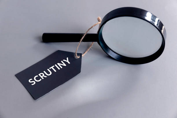 istock Magnifying Glass with 'Scrutiny' Tag on Grey Background 2190255035