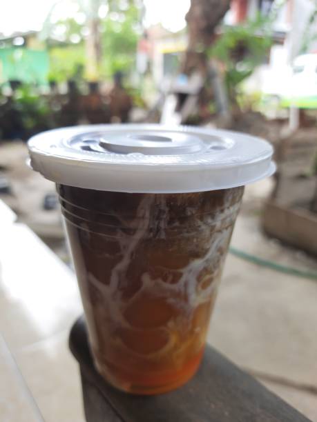 istock Refreshing Cold Brew Coffee With Swirls of Cream in a Plastic Cup 2190255428