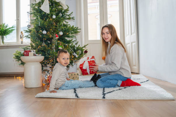 istock Mother and Son Celebrating Christmas Near a Decorated Tree 2190255726