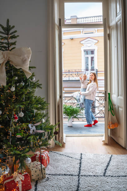 istock Mother and Son Celebrating Christmas Near a Decorated Tree 2190256630