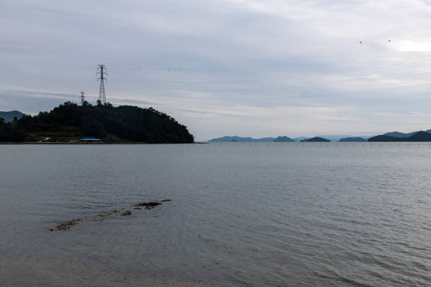 istock power transmission tower and sea 2190257736