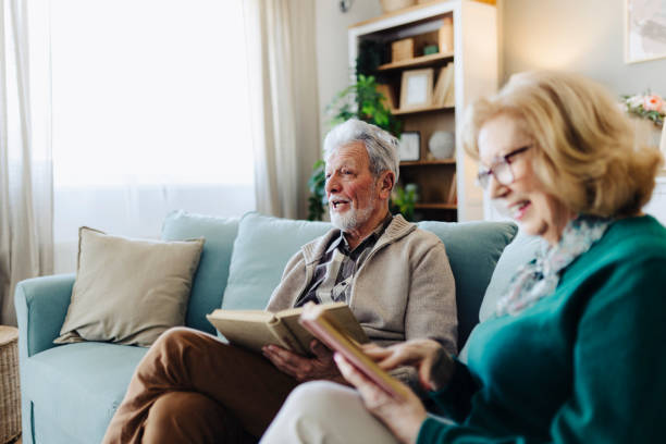 istock Senior couple reading book at home 2190258026