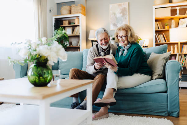 istock Senior couple reading book at home 2190258424