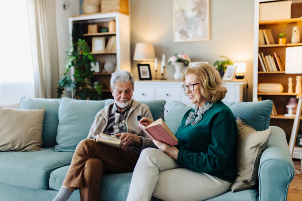 istock Senior couple reading book at home 2190258511