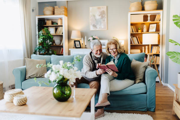 istock Senior couple reading book at home 2190259010