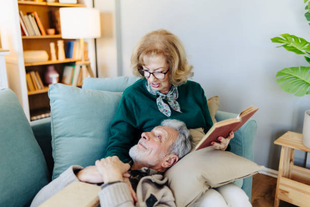 istock Senior couple reading book at home 2190259064