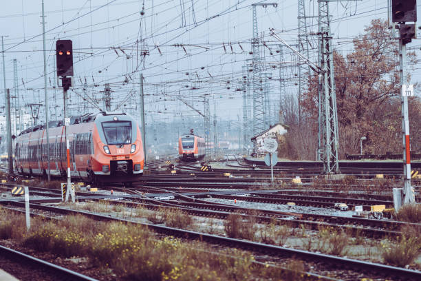 A dynamic view of intersecting train tracks at Frankfurt Main Station during sunset on March 2, 2022, highlighting the bustling and intricate rail network.