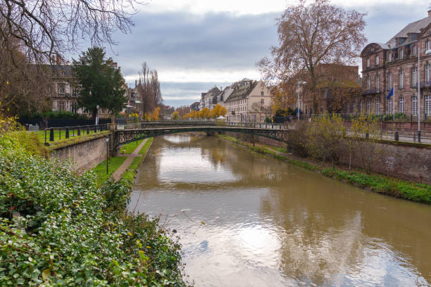 istock Tranquil canal scene in Strasbourg with a historic bridge. 2190261790