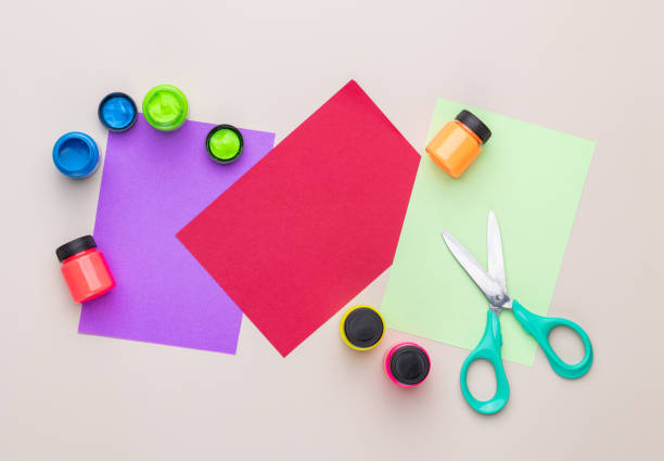 istock Paint, paper and school supply over light brown background with copy space 2190263863