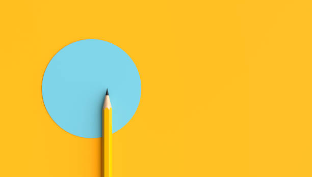 istock Yellow pencil pointing light blue circle on vivid yellow background 2190265574