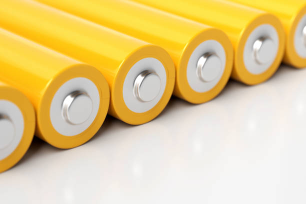 istock Row of yellow aa batteries lying on white background 2190266448