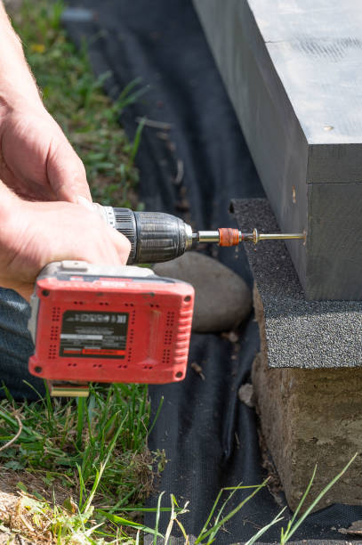 istock A man is drilling screws into wooden beams 2190269563