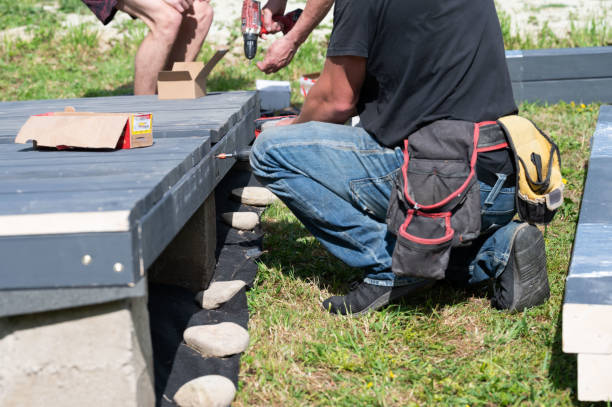 istock A master carpenter is driving large screws to secure the frame and floor in the gazebo. 2190269609