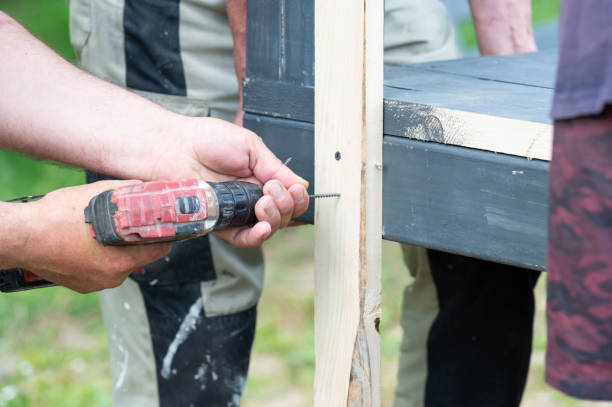 istock Screwing the board with a screwdriver, installing a wooden gazebo. 2190269676
