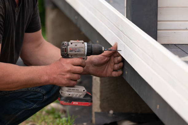 istock The builder attaches the wall to the gazebo frame using screws and a screwdriver. 2190269952