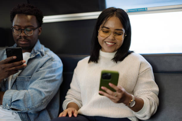 istock Two Friends Relaxing and Using Smartphones During a Bus Ride 2190270087