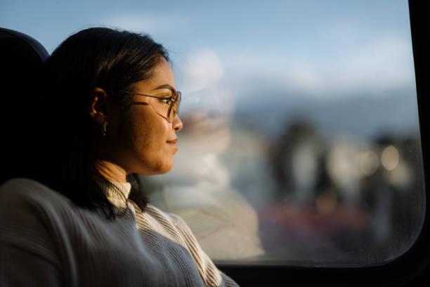 istock Thoughtful Woman Looking Outside Window On Sunny Day 2190270121