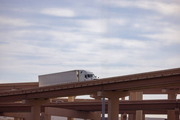 istock Transport Truck Driving on Elevated Highway Under a Clear Sky 2190271727