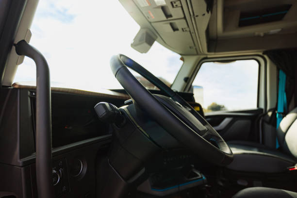 Interior of a modern industrial truck showcasing the steering wheel and dashboard in detail.