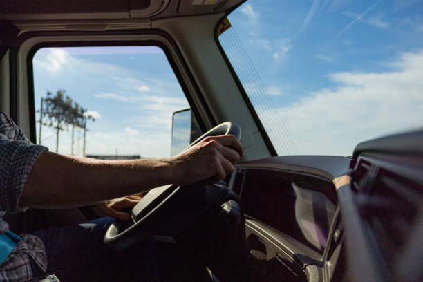 Truck Driver Operating Vehicle on a Sunny Day on the Open Road