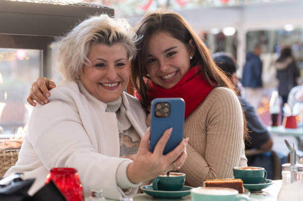 istock Mother and daughter taking a selfie while having coffee 2190273605