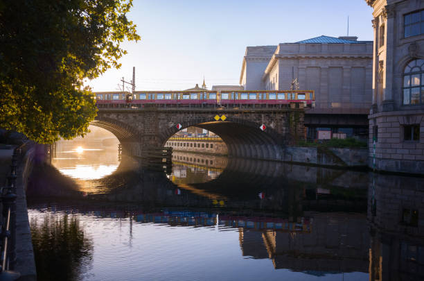 istock s-bahn train passes monbijou bridge spanning a calm spree river at Mudeum Island in Berlin 2190275282