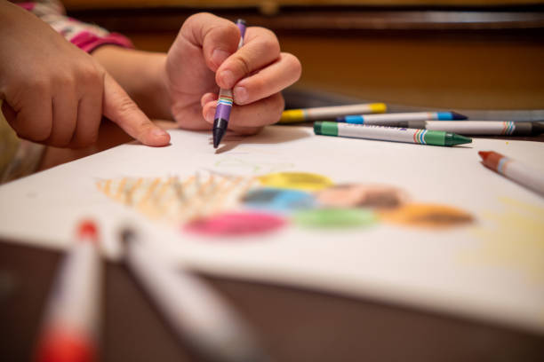 istock Draw with colored pencils on a white sheet of paper. 2190276885