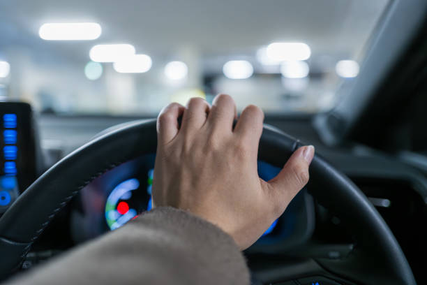 istock Hands behind the wheel of a car 2190278000