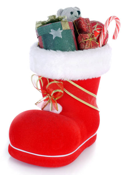 Red Santa's shoe stuffed with Christmas presents over white background