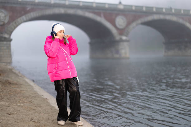 Portrait of a student girl against the background of white historical architecture of the city, spring