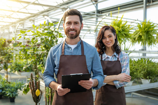 istock Two workers in a greenhouse looking positive and contented 2190284208