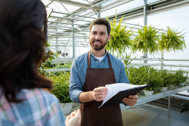 istock Two professionals talking in the greenhouse discussing plant cultivation 2190284210