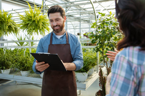 istock Greenhouse worker talking to a supervisor of quality control 2190284219