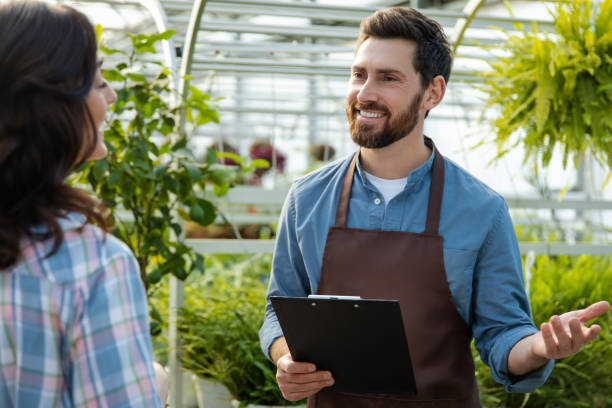 istock Two professionals talking in the greenhouse discussing plant cultivation 2190284225