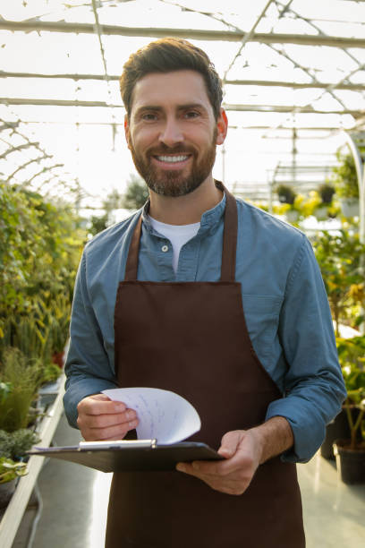 istock Male supervisor working in a greenhouse and looking positive 2190284231