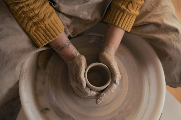 istock Hands of woman working with pottery wheel. Top view 2190286394