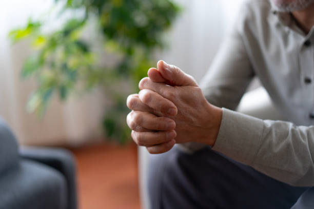 istock Senior man clasping hands showing anxiety and stress 2190287723