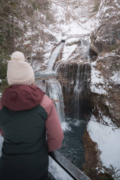 istock Tourist Observing Frozen Waterfalls in Ordesa, Pyrenees 2190287768