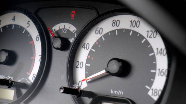 istock Close-up of a car speedometer and fuel gauge dashboard with open doors warning light illuminated, vehicle interior detail closeup, speed and fuel monitoring, used cars buying selling abstract concept 2190287812