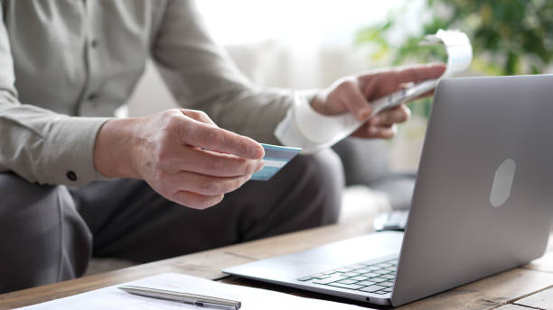 istock Businessman making online payment using credit card and laptop 2190288635
