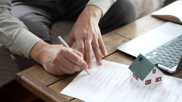istock Real estate agent signing a contract for a new house purchase 2190289267