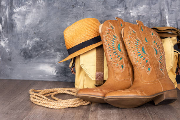 istock boots, hat and a canvas bag against a gray wall. Adventure and travel concept. Space for text. 2190292365